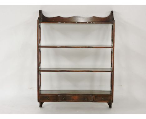 ##A George III style mahogany four tier wall shelf, with three drawer base, 69cm wide, 92cm high