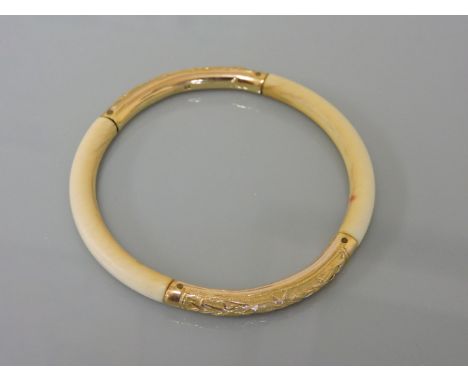 A 19th century ivory slave bangle, with gold chased sections