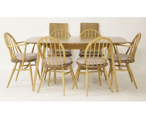 An Ercol light elm dining table, complete with two leaves, 219cm extended, and six dining chairs to include two elbows