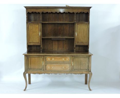 ##A late Victorian oak dresser, with raised shelf and cupboard back and cabriole legs, 108cm wide, 55cm deep, 206cm high