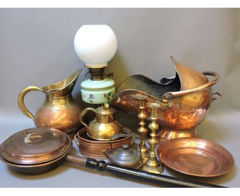 A collection of metal wares, to include a pair of brass candlesticks, a copper dish, a coal scuttle, and a Victorian oil lamp