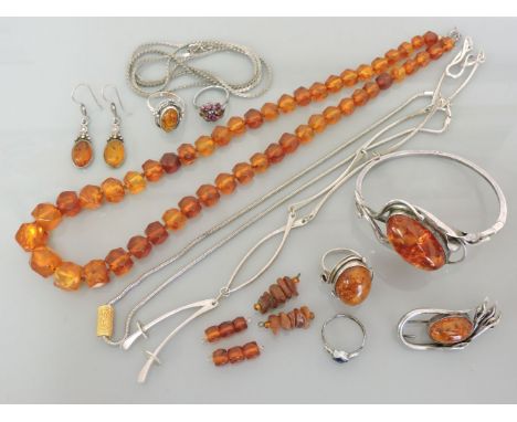 A quantity of amber and costume jewellery, to include a graduated faceted amber bead necklace, an amber cabochon hinged bangl