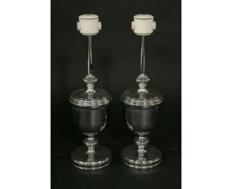 A pair of chrome urn shaped table lamps, lacking shades, 68cm high, a chrome standard lamp with a green plastic shade and thr