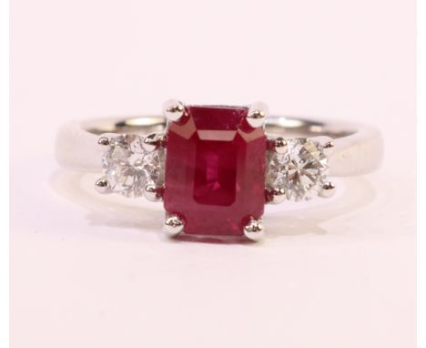 18ct white gold three stone emerald cut ruby and round brilliant cut diamond ring hallmarked   Condition Report  Ruby = 1.88 