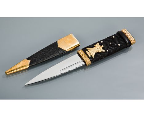 BLACK WATCH OFFICERS SKEAN DHU with oval cairngorm finial, carved ebonised hilt, steel blade and leather sheath, made by T Ke