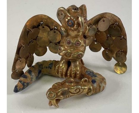 A South American Inca inspired yellow metal winged beast, with polished stone detail to eyes and body and set holding a polis