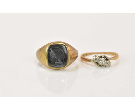 A 9ct gold signet ring with engraved hardstone plaque, size T, and a 9ct gold three stone ring, size M, combined 6.48g (2).