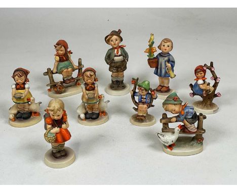 GOEBEL: nine ceramic figures of children in traditional dress, largest height 14.5cm.