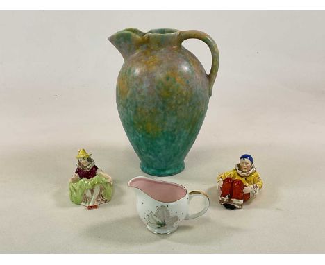 Art Deco ceramics, comprising two seated figures, a large water pitcher, height 31cm, and a Susie Cooper cream jug (4).