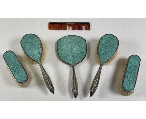A George V hallmarked silver mounted and shagreen backed six piece dressing table set comprising hand mirror, two pairs of br