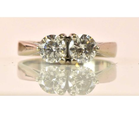 A white metal and diamond two stone ring, each three claw set round brilliant cut stone weighing approx 0.50ct, size K 1/2, a