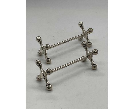 WILLIAM HUTTON &amp; SONS; a pair of George V hallmarked silver knife rests, Sheffield 1939, length 8cm, combined approx 3ozt