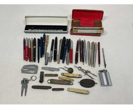 A large collection of various vintage and modern pens, also a small group of pocket knives, lighter, whistle, etc (qty).