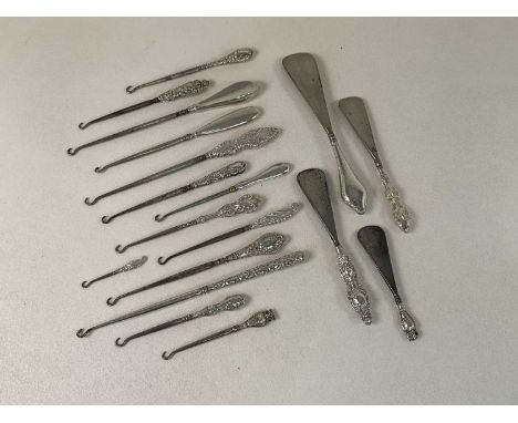A group of eighteen hallmarked silver sheath handled shoe horns, glove hooks and button hooks, two in the form of owls, vario