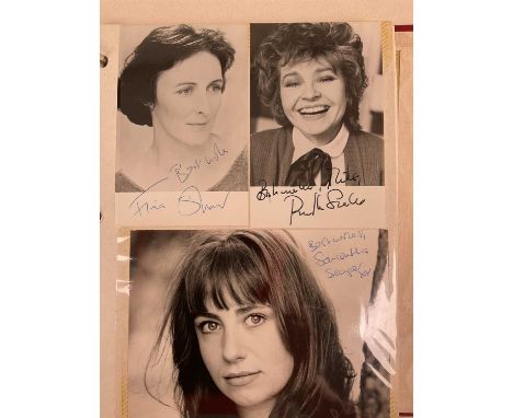 A red ring binder containing approximately one hundred pages of actresses' signed promotional cards, some signed papers and e