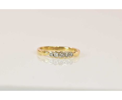A 9ct yellow gold graduated five stone collet set diamond ring, the diamonds totalling 0.20ct, size Q 1/2, approx 2.7g.