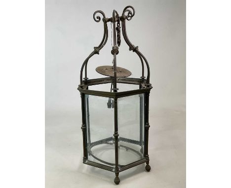 A large 19th century brass hexagonal hall lantern with bevelled glass plates (two missing), height 94cm.
