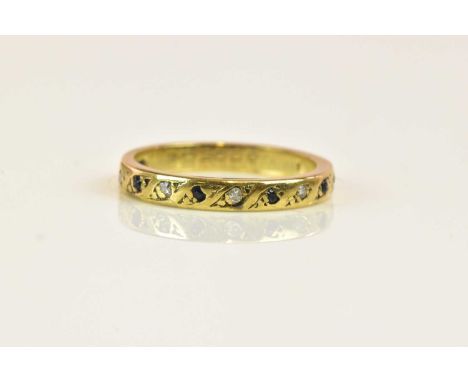 A yellow metal half eternity ring set with small rubover sapphires and diamonds, size K, approx 2g.