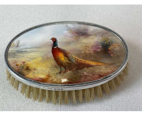 JAMES STINTON FOR ROYAL WORCESTER; a silver mounted brush with hand painted oval plaque depicting a pheasant in landscape, si