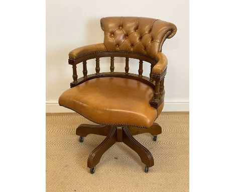 A button leather upholstered and spindle back mahogany framed captain's desk/tub chair.