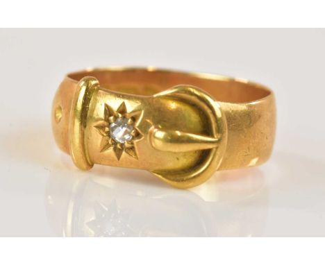 An 18ct yellow gold diamond set buckle ring, size O, approx 5.7g.