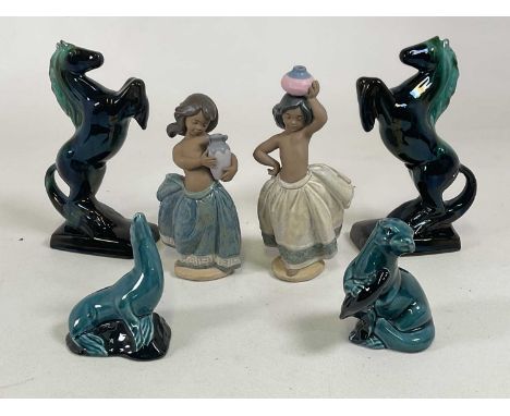 A group of ceramic figures, comprising a Poole Pottery seal and an otter, two Lladro figures of girls carrying water vessels 