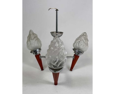 An Art Deco amber bakelite and chrome three light ceiling light with frosted flaming torch shades, height 48cm.