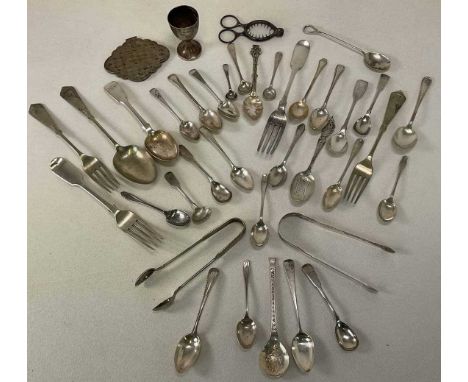 A group of silver and white metal flatware including two table forks, sugar tongs, various teaspoons, also an egg cup and the