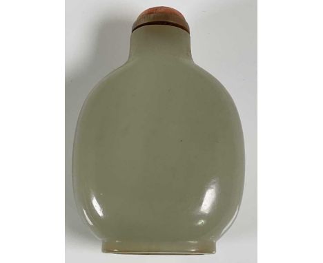 A Chinese carved jade snuff bottle with coral bead to the stopper, length 6.25cm.Condition Report: No visible signs of any da