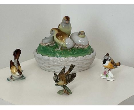 An early 20th century hand painted ceramic egg basket, modelled as a group of hatching chicks, height 15cm, together with thr