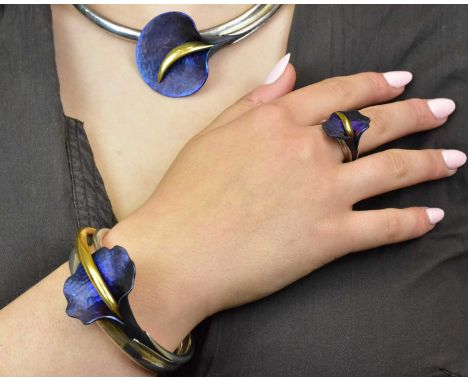 An unusual suite of silver jewellery modelled as calla lilies with torque collar, matching bangle and matching ring, each pie