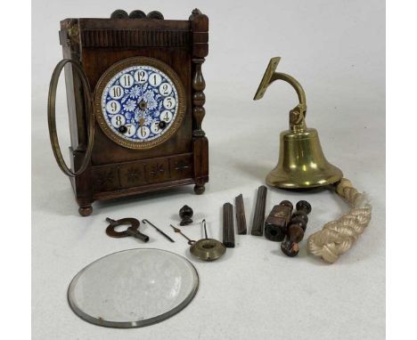 A wooden cased mantel clock, with enamelled face requiring extensive repairs, 27 x 19 x 12cm, together with a brass bell (2).