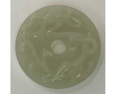 A Chinese jade bi disc, with carved relief decoration to the front and incised decoration to the reverse, diameter 55mm.Condi