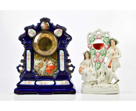 SPIKE MILLIGAN; a decorative ceramic mantel clock, height 36cm and a Staffordshire figure group, height 30cm, both from the e