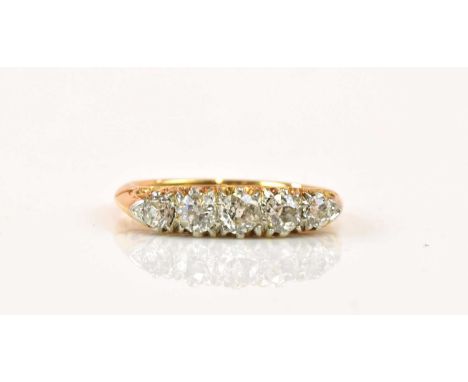 An 18ct yellow gold five stone graduated diamond ring, the central diamond weighing approx 0.20ct, size K 1/2, approx 4.1g.