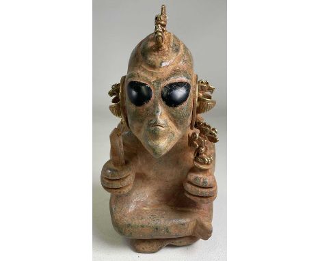 A large South American Inca inspired figure with exaggerated skull, yellow metal mounted and inset headpiece, ear guards and 