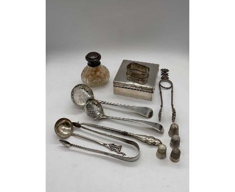 A group of small silver and white metal including an early Victorian hallmarked silver pierced sugar sifter, London 1845, a f