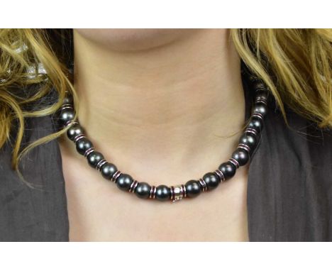 An 18ct white gold, white metal Tahitian pearl and ruby set necklace, the well matched pearls each diameter approx 11.5mm int