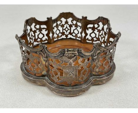 GEORGE IVORY; a large early Victorian hallmarked silver wooden based bottle coaster, with pierced shaped frame, London 1846, 