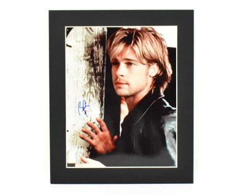 BRAD PITT; a signed photograph of Pitt in his younger years, signed 'BP' in blue marker, in cardboard mount, 31 x 25.5cm.   P