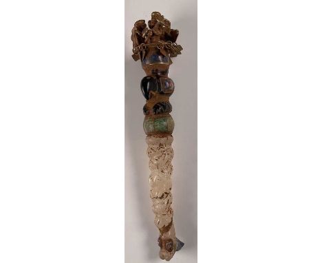 A South American Inca inspired wrythen twisted carved crystal yellow metal mounted polished stone set sceptre, with figural a