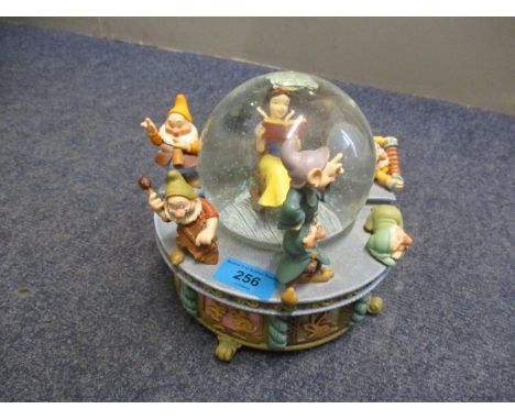 A Disney Snow White and the Seven Dwarfs snow globe, playing Whistle a Happy Tune 