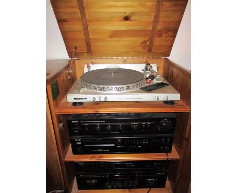 A Denon stacking hi-fi with Aiwa direct drive turn table, amplifier, CD player and cassette deck housed within a pine cabinet