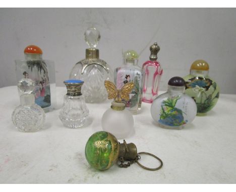 A group of nine various glass scent bottles to include four oriental snuff bottles and a cranberry overlaid and cut bottle wi