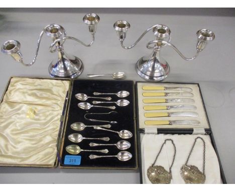 A pair of silver plated candelabras and mixed silver plate, together with two silver decanter labels and silver teaspoons 