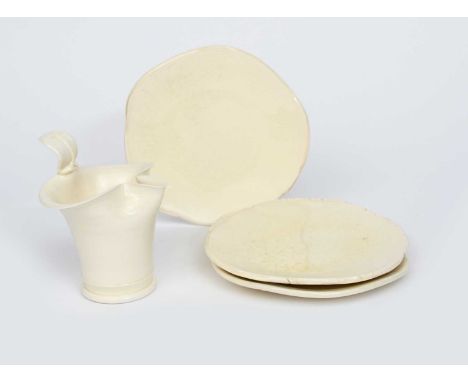 Takeshi Yasuda (born 1943)a creamware jug flaring cylindrical form covered in a light honey glaze, and three plain creamware 