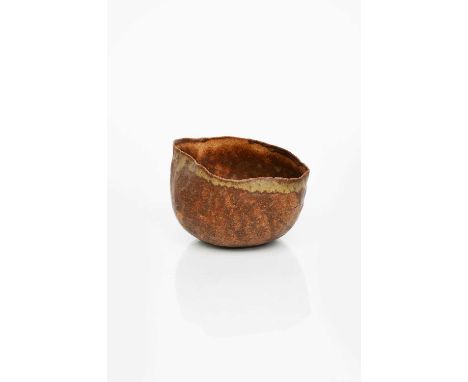 Φ Ewen Henderson (1934-2000)a hand-built stoneware chawan, irregular form, rust body with green glaze to rim,unsigned17cm. wi