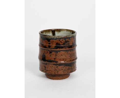Φ William Bill Marshall (1923-2007)a Leach Pottery stoneware unomi, footed, cylindrical form, covered in a tenmoku and rust g