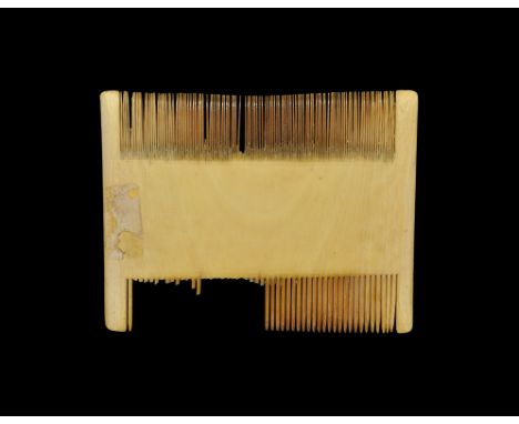 19th century AD. A rectangular lentoid-section comb with saw-cut teeth, fine to one edge and coarse to the other. 51 grams, 1