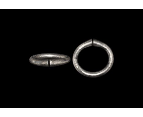 6th century AD. A round-section silver penannular hoop with clubbed ends; Baltic workmanship. Cf. Sedov, B.B. Finno-Ugri i Ba